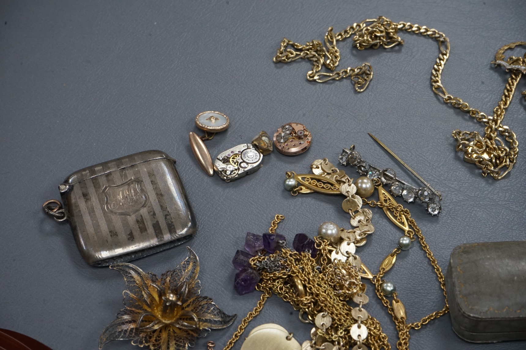 A quantity of assorted costume jewellery and other items including wrist watches, watch movements and a silver vesta case.